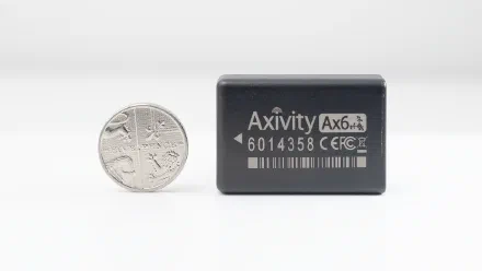 An AX6 lying beside the same five-pence coin, the same width as the AX3